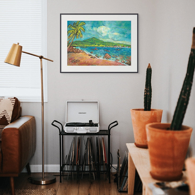Living room with a painting of a coastal scene in the Bay Islands of Honduras, a record player, and potted plants.