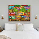 Colorful abstract painting above a bed in a bedroom setting