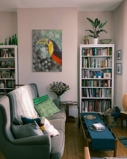 Living room with a couch, bookshelves, and decorative items.